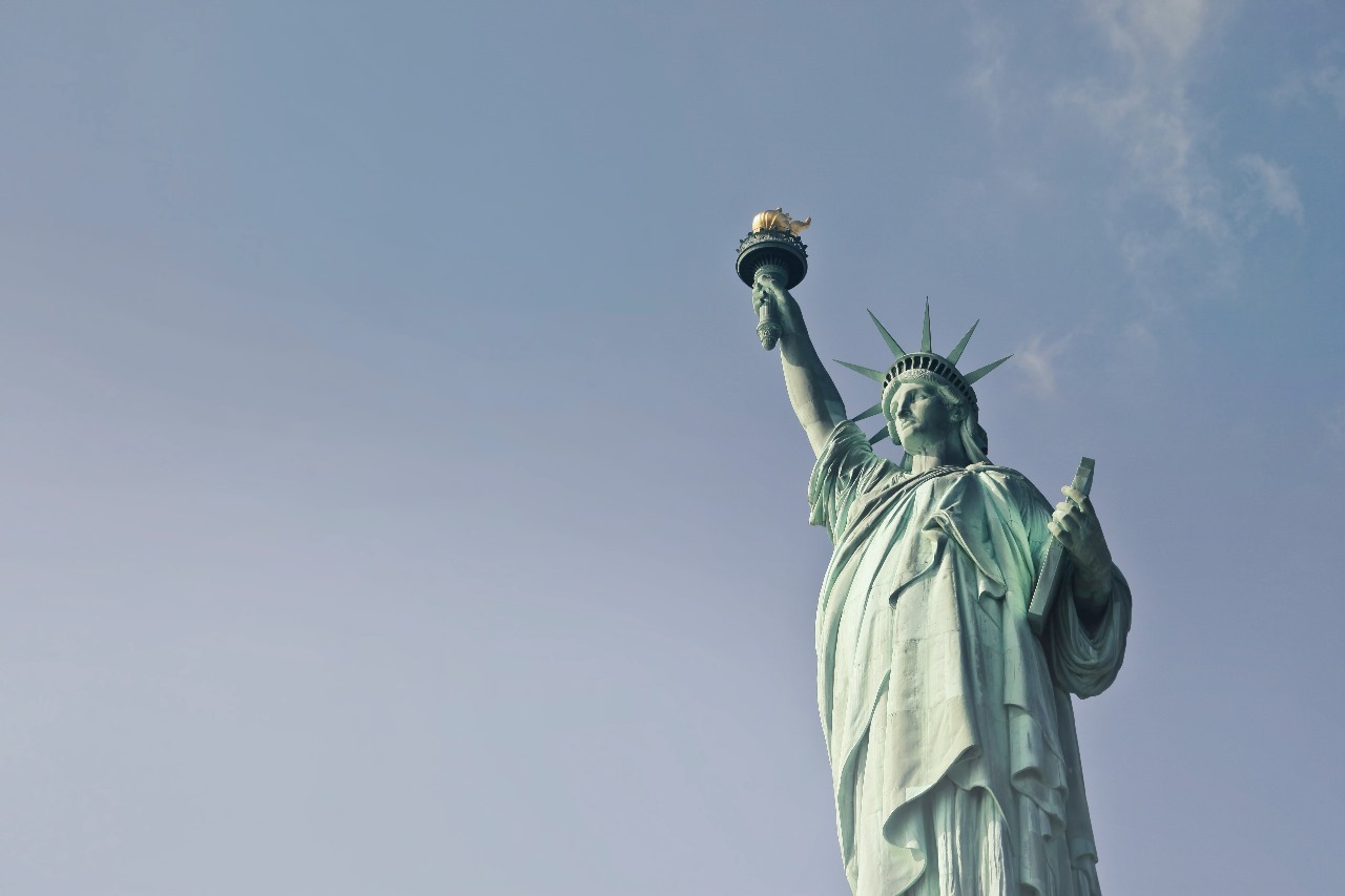 A statue of liberty with the sky in the background