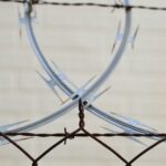 A barbed wire fence with two intersecting circles.
